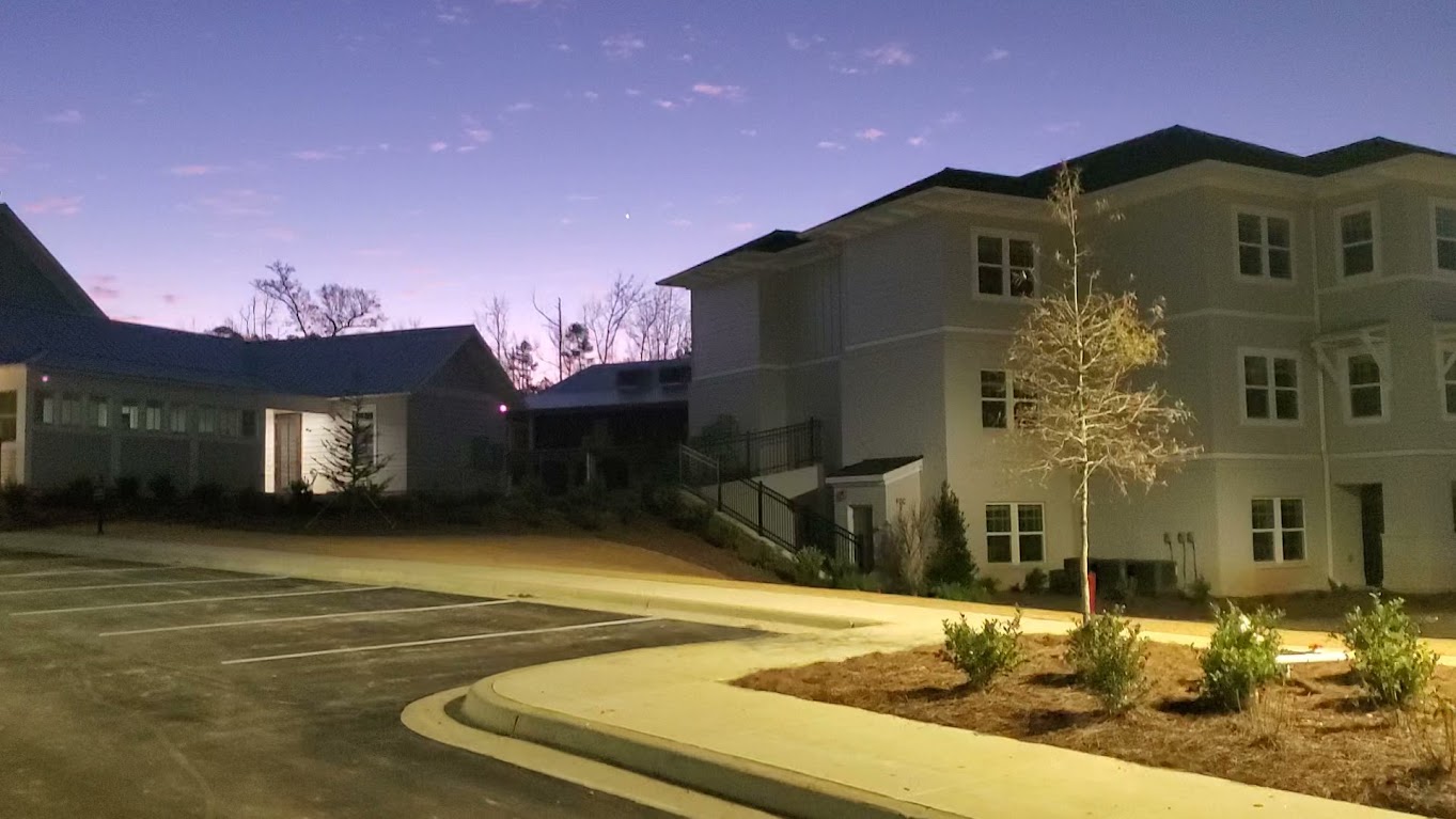 Greystone multifamily buildings illuminated at dusk